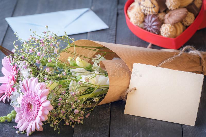 A Card And A Bouquet Of Flowers